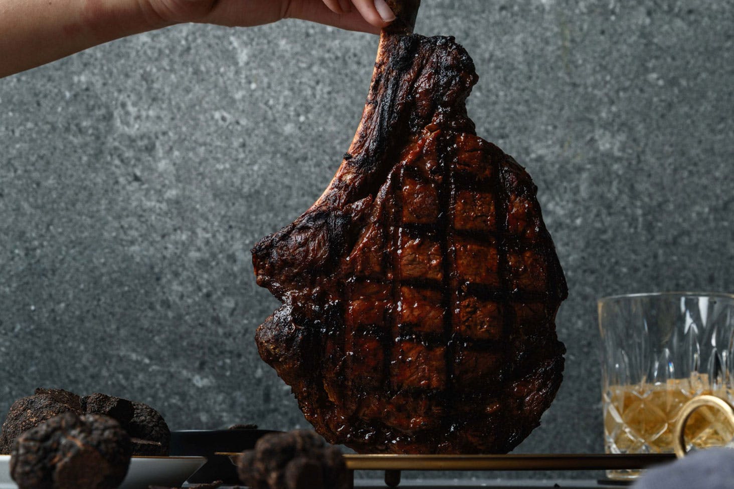 a person holding a perfectly cooked cut of meat